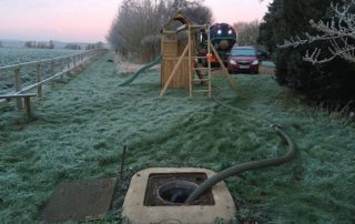 Septic tank being emptied by tanker