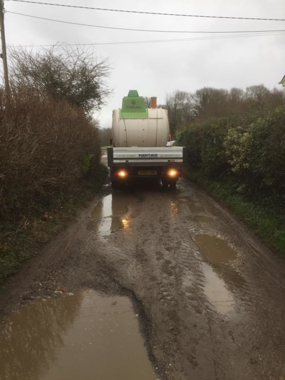 Mantair van delivering septic tank for insurance claim
