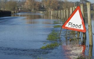 Flooded road with sign