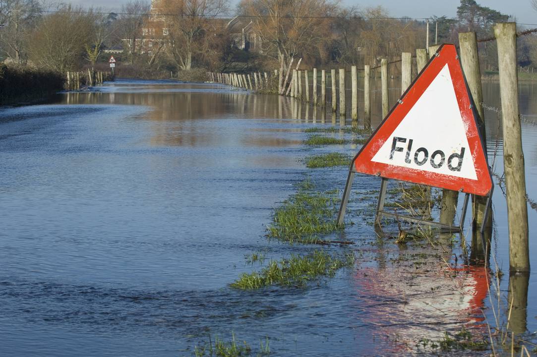 Flooded road with sign
